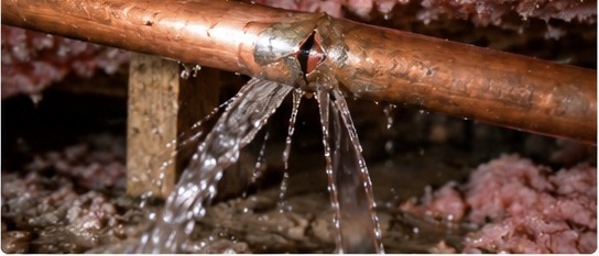 Water spraying from a burst pipe