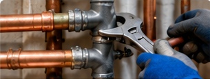 Plumber repairing copper piping