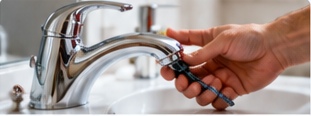 Plumber repairing faucet hardware